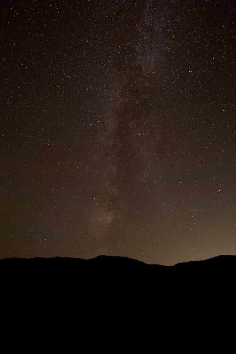 The Milky Way rising above a dark ridge line